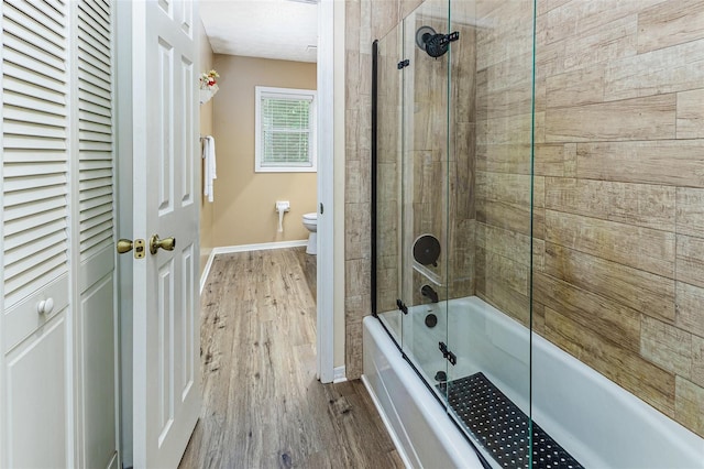 418 N Rd, Lakeland, FL 33809 - full bathroom with toilet, wood finished floors, shower / tub combination, and baseboards