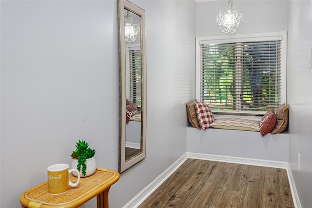 418 N Rd, Lakeland, FL 33809 - corridor featuring wood finished floors, baseboards, and a chandelier