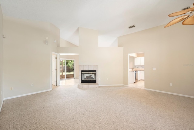 630 Heather Glen Loop, Winter Haven, FL 33884 - unfurnished living room with a ceiling fan, light colored carpet, high vaulted ceiling, baseboards, and a fireplace