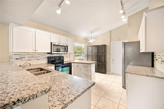630 Heather Glen Loop, Winter Haven, FL 33884 - kitchen with appliances with stainless steel finishes, rail lighting, a sink, backsplash, and a textured ceiling