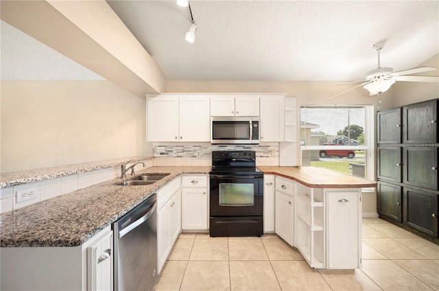 630 Heather Glen Loop, Winter Haven, FL 33884 - kitchen with stainless steel appliances, a peninsula, a sink, decorative backsplash, and white cabinetry
