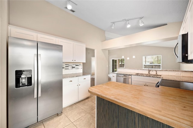 630 Heather Glen Loop, Winter Haven, FL 33884 - kitchen with stainless steel appliances, a sink, backsplash, light tile patterned flooring, and track lighting