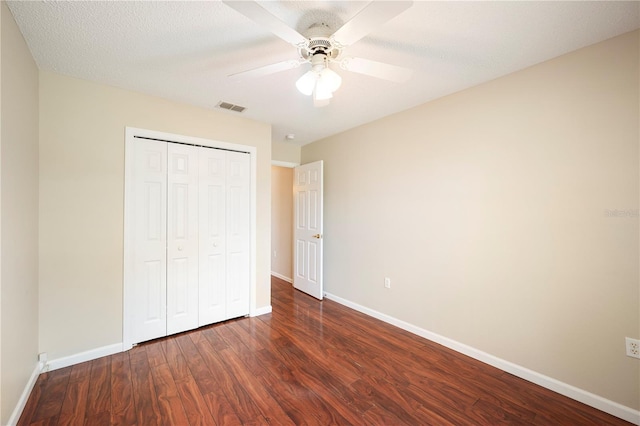 630 Heather Glen Loop, Winter Haven, FL 33884 - unfurnished bedroom with baseboards, dark wood-type flooring, a closet, and ceiling fan
