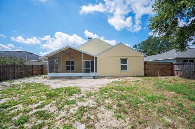 630 Heather Glen Loop, Winter Haven, FL 33884 - rear view of property featuring a sunroom and a fenced backyard