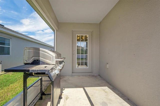 648 Lorient Dr, Eagle Lake, FL 33839 - view of exterior entry with stucco siding and a patio area
