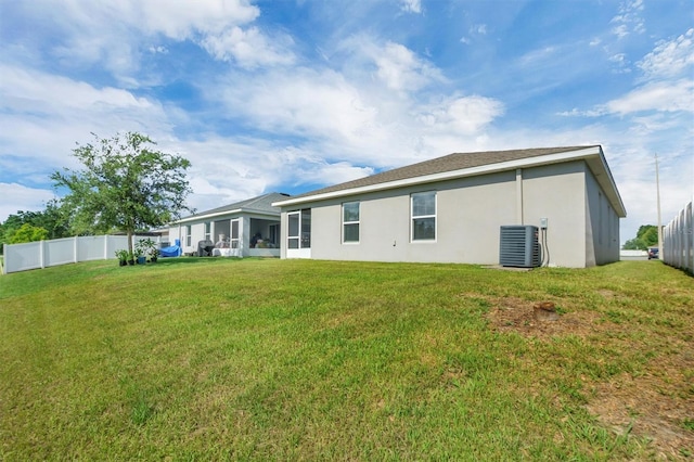 648 Lorient Dr, Eagle Lake, FL 33839 - rear view of house with stucco siding and a sunroom
