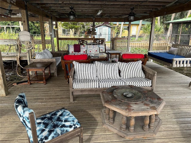 9402 Cat Track Trl, Lake Wales, FL 33898 - wooden deck with a storage unit, a ceiling fan, and an outbuilding