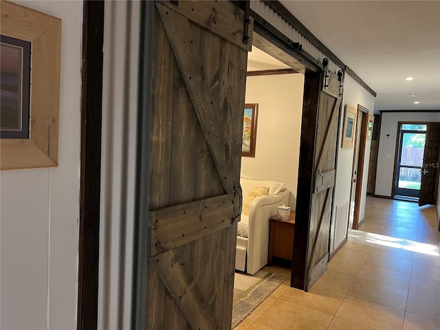 9402 Cat Track Trl, Lake Wales, FL 33898 - hallway with a barn door, light tile patterned floors, recessed lighting, and baseboards