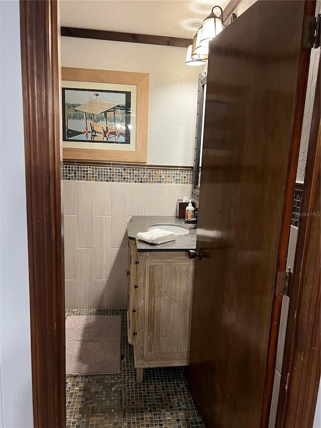 9402 Cat Track Trl, Lake Wales, FL 33898 - bathroom featuring tile walls, a wainscoted wall, tile patterned flooring, and a sink