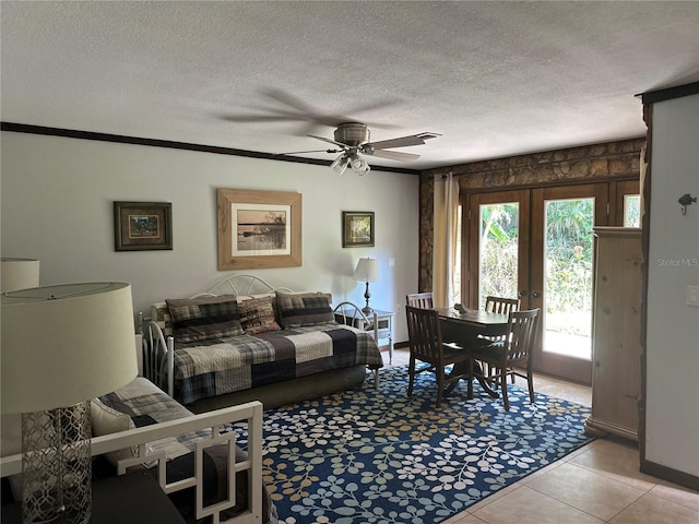 9402 Cat Track Trl, Lake Wales, FL 33898 - living room featuring a ceiling fan, a textured ceiling, light tile patterned flooring, baseboards, and french doors