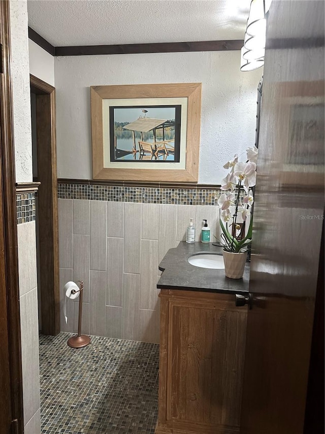 9402 Cat Track Trl, Lake Wales, FL 33898 - bathroom featuring tile walls, vanity, and wainscoting