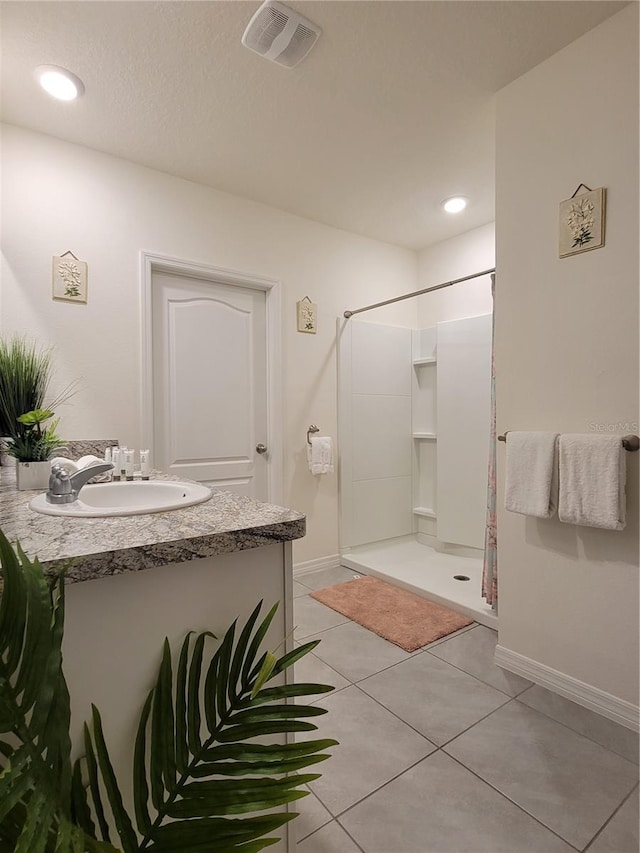 1378 Fox Squirrel Dr, Davenport, FL 33897 - bathroom with a shower stall, baseboards, tile patterned flooring, vanity, and recessed lighting