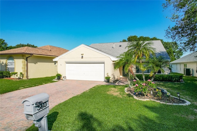 560 Saint Andrews Rd, Winter Haven, FL 33884 - ranch-style home featuring an attached garage, decorative driveway, a front yard, and stucco siding