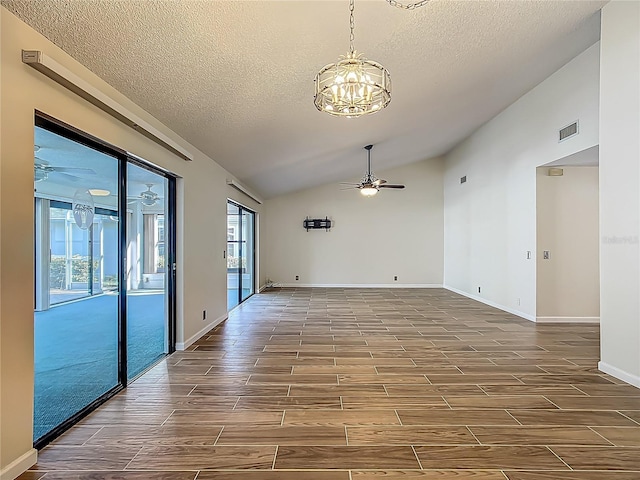 560 Saint Andrews Rd, Winter Haven, FL 33884 - unfurnished room with ceiling fan, vaulted ceiling, a chandelier, a textured ceiling, and wood finish floors