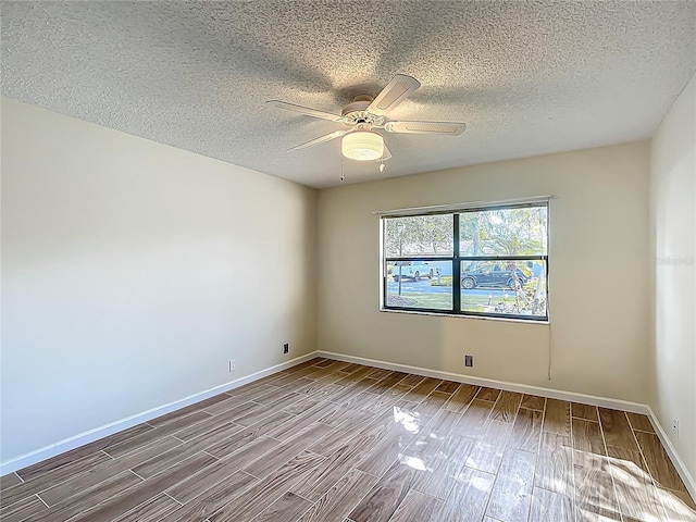 560 Saint Andrews Rd, Winter Haven, FL 33884 - unfurnished room with wood finished floors, a textured ceiling, a ceiling fan, and baseboards