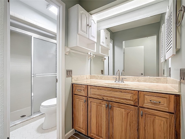 560 Saint Andrews Rd, Winter Haven, FL 33884 - full bathroom with a shower stall, toilet, vanity, and tile patterned flooring
