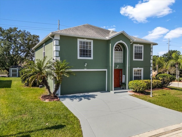 1800 Emily Dr, Winter Haven, FL 33884 - view of front facade featuring an attached garage, concrete driveway, stucco siding, a front lawn, and a shingled roof