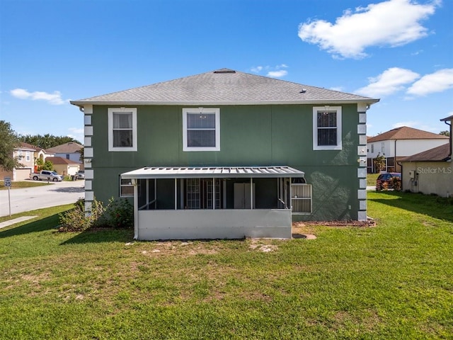 1800 Emily Dr, Winter Haven, FL 33884 - back of property featuring a sunroom, a lawn, and stucco siding