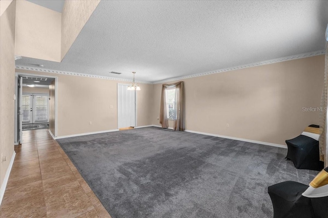 1800 Emily Dr, Winter Haven, FL 33884 - unfurnished living room with a chandelier, crown molding, a textured ceiling, baseboards, and tile patterned flooring
