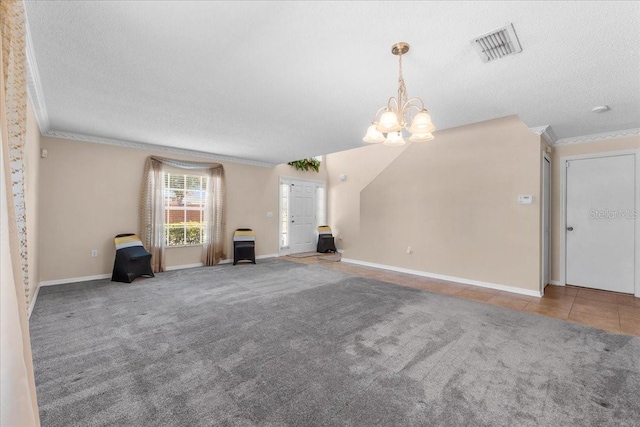 1800 Emily Dr, Winter Haven, FL 33884 - unfurnished living room featuring a textured ceiling, a chandelier, crown molding, baseboards, and carpet flooring