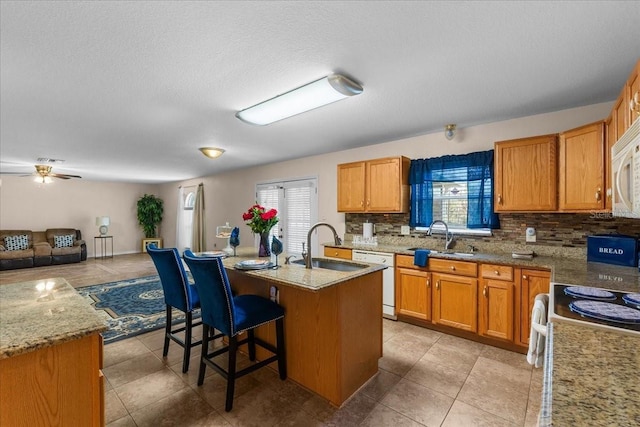 1800 Emily Dr, Winter Haven, FL 33884 - kitchen featuring white appliances, a sink, open floor plan, tasteful backsplash, and a textured ceiling