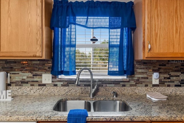 1800 Emily Dr, Winter Haven, FL 33884 - kitchen featuring a sink, tasteful backsplash, and light stone countertops