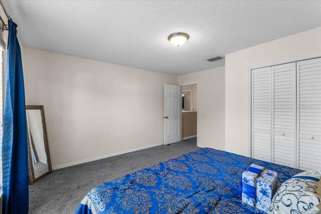 1800 Emily Dr, Winter Haven, FL 33884 - bedroom with carpet floors, a textured ceiling, baseboards, and a closet