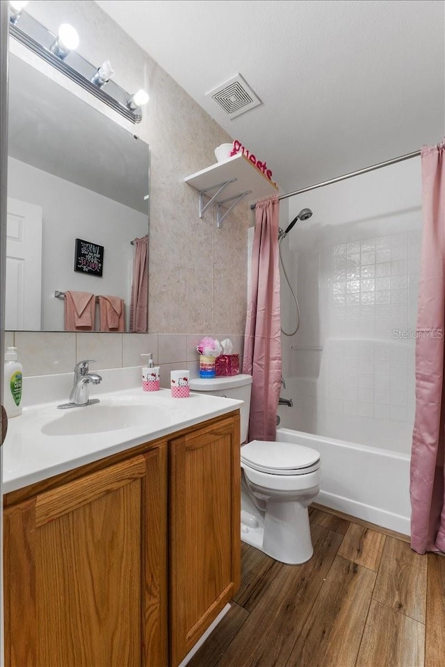 1800 Emily Dr, Winter Haven, FL 33884 - full bath with toilet, wood finished floors, shower / tub combo, and vanity