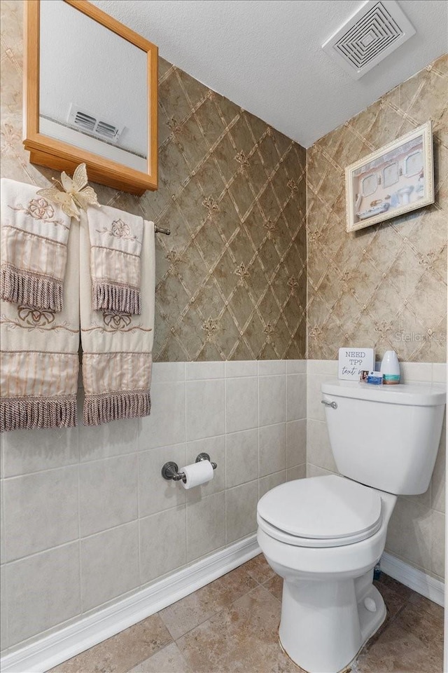 1800 Emily Dr, Winter Haven, FL 33884 - half bathroom featuring toilet and tile walls