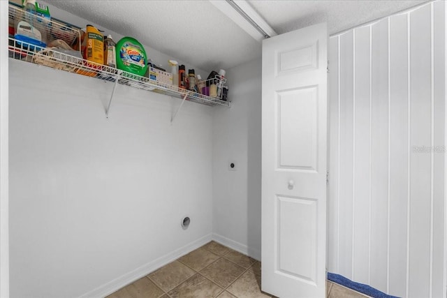 1800 Emily Dr, Winter Haven, FL 33884 - laundry area with hookup for an electric dryer, light tile patterned flooring, and baseboards