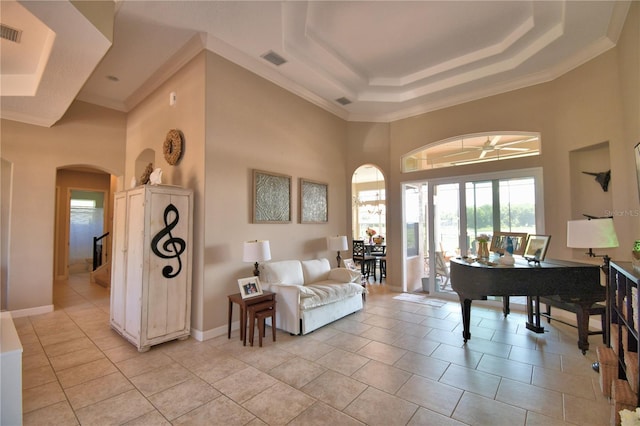 2340 Pinehurst Ct, Davenport, FL 33837 - living area featuring arched walkways, a towering ceiling, crown molding, a tray ceiling, and ceiling fan