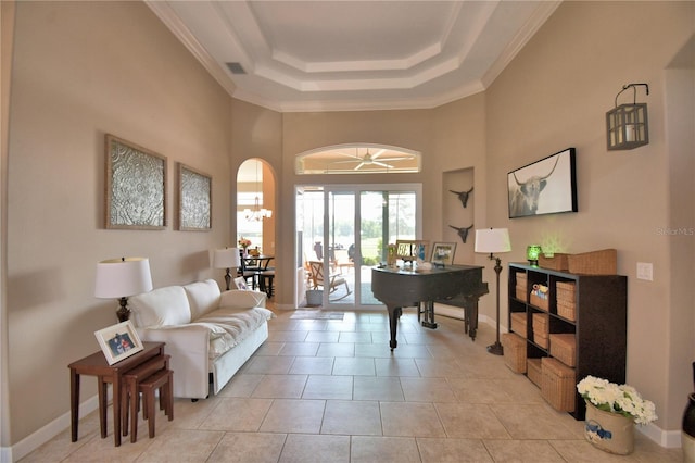 2340 Pinehurst Ct, Davenport, FL 33837 - living area featuring a tray ceiling, a towering ceiling, light tile patterned floors, crown molding, and arched walkways