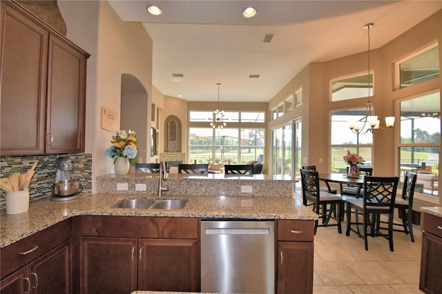 2340 Pinehurst Ct, Davenport, FL 33837 - kitchen featuring dishwasher, a chandelier, a peninsula, and light tile patterned floors