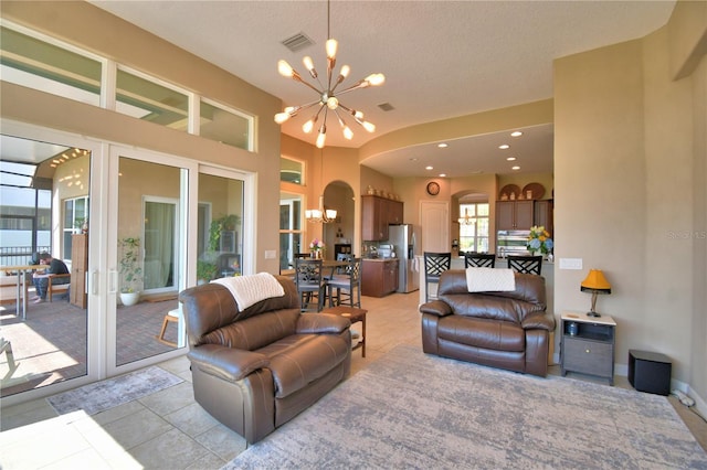 2340 Pinehurst Ct, Davenport, FL 33837 - living area with a chandelier, arched walkways, and light tile patterned floors