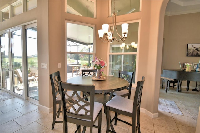 2340 Pinehurst Ct, Davenport, FL 33837 - dining space featuring healthy amount of natural light, light tile patterned flooring, a chandelier, crown molding, and a towering ceiling