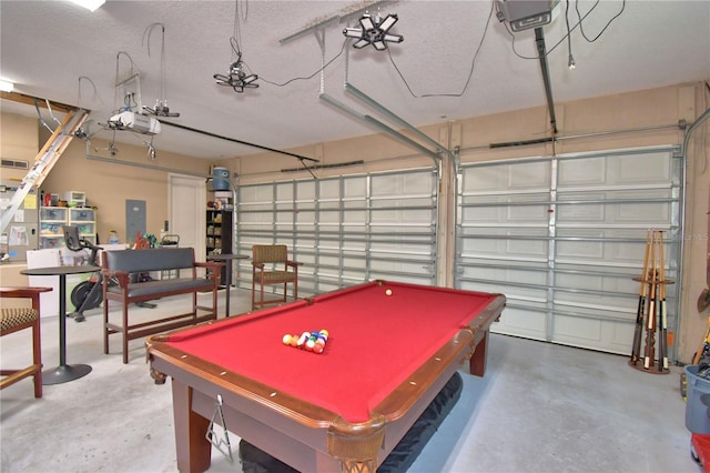 2340 Pinehurst Ct, Davenport, FL 33837 - game room featuring concrete flooring, a garage, electric panel, billiards, and a textured ceiling