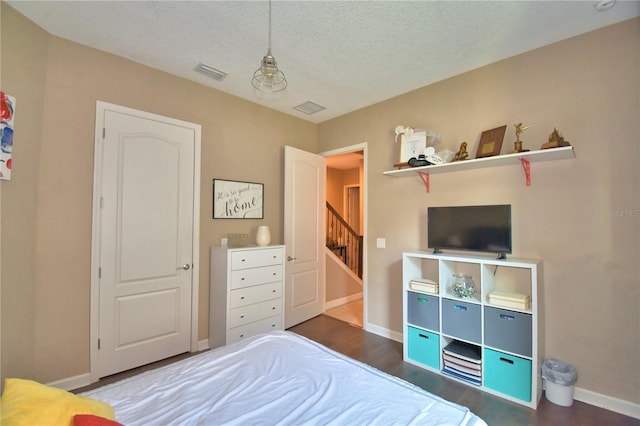 2340 Pinehurst Ct, Davenport, FL 33837 - bedroom featuring wood finished floors and a textured ceiling