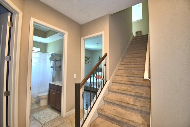 2340 Pinehurst Ct, Davenport, FL 33837 - staircase with tile patterned floors and baseboards