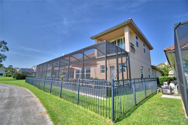 2340 Pinehurst Ct, Davenport, FL 33837 - view of property exterior with stucco siding, glass enclosure, and a tiled roof