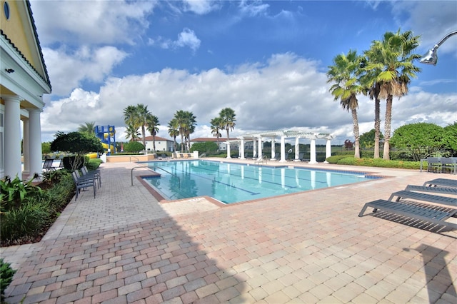 2340 Pinehurst Ct, Davenport, FL 33837 - community pool with a pergola and a patio area