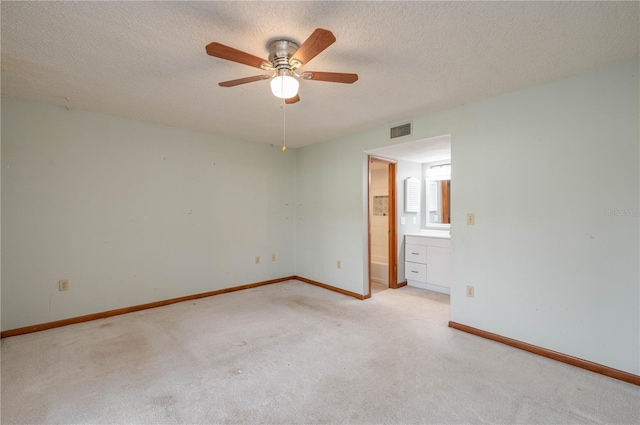 5102 Village Ct Unit E-2, Lake Wales, FL 33898 - unfurnished room featuring light carpet, a ceiling fan, baseboards, and a textured ceiling