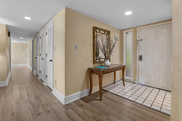 713 Olde Camelot Cir Unit 3303-4, Haines City, FL 33844 - entrance foyer featuring wood finished floors, baseboards, and recessed lighting