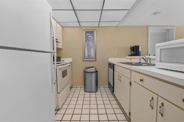 713 Olde Camelot Cir Unit 3303-4, Haines City, FL 33844 - kitchen featuring white appliances, a sink, light countertops, light tile patterned floors, and a drop ceiling