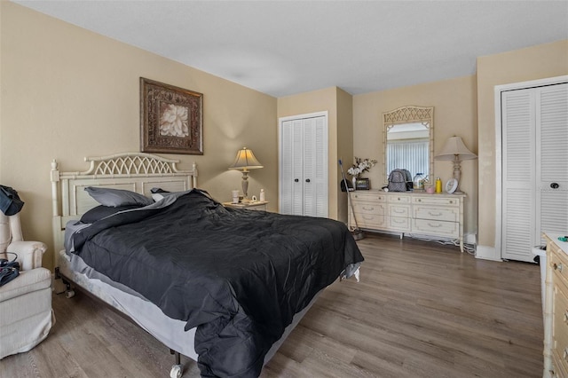 713 Olde Camelot Cir Unit 3303-4, Haines City, FL 33844 - bedroom with dark wood-type flooring, two closets, and baseboards