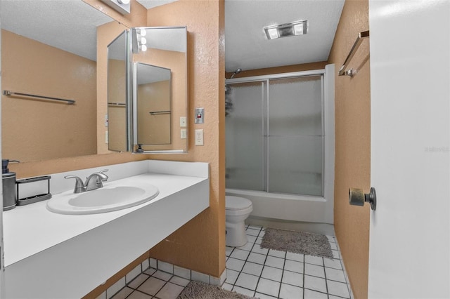 713 Olde Camelot Cir Unit 3303-4, Haines City, FL 33844 - bathroom featuring toilet, vanity, combined bath / shower with glass door, tile patterned flooring, and a textured ceiling