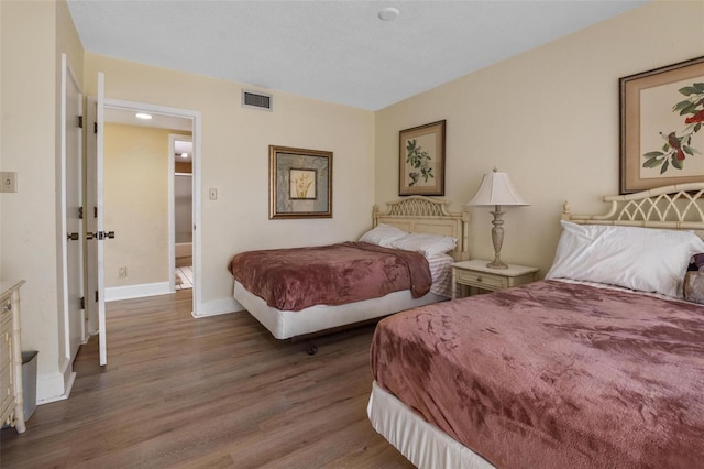 713 Olde Camelot Cir Unit 3303-4, Haines City, FL 33844 - bedroom with wood finished floors and baseboards