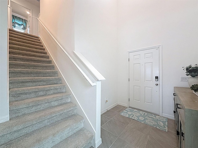 912 Scrub Oak Hammock Rd, Davenport, FL 33837 - tiled entrance foyer with stairway, baseboards, and a towering ceiling