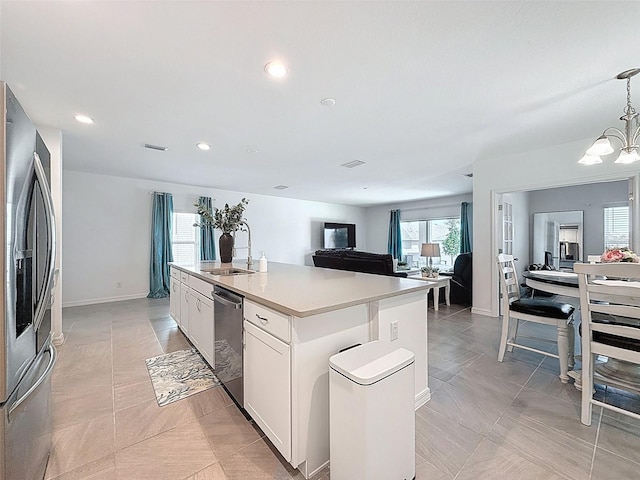 912 Scrub Oak Hammock Rd, Davenport, FL 33837 - kitchen with stainless steel appliances, a sink, open floor plan, a chandelier, and a center island with sink