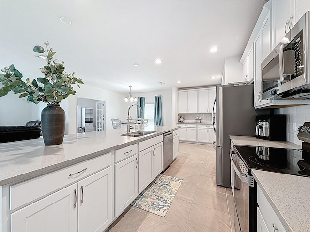 912 Scrub Oak Hammock Rd, Davenport, FL 33837 - kitchen featuring appliances with stainless steel finishes, a sink, decorative backsplash, white cabinets, and recessed lighting