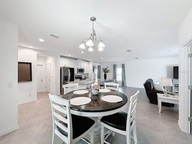 912 Scrub Oak Hammock Rd, Davenport, FL 33837 - dining area with a chandelier, baseboards, light marble finish flooring, and recessed lighting